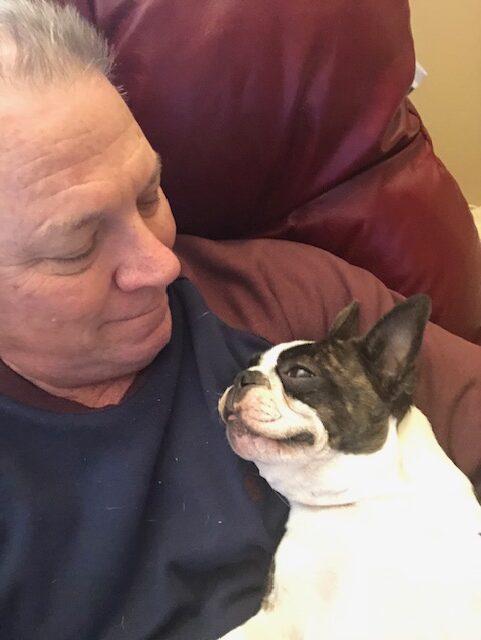 Man and dog sharing a close, affectionate moment.